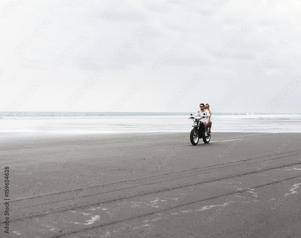 Fototapeta premium Young beautiful couple riding motorcycle