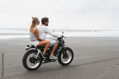 Young beautiful couple riding motorcycle