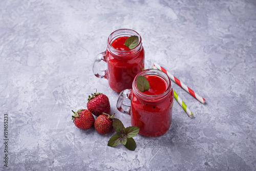 Strawberry smoothie in glass jars
