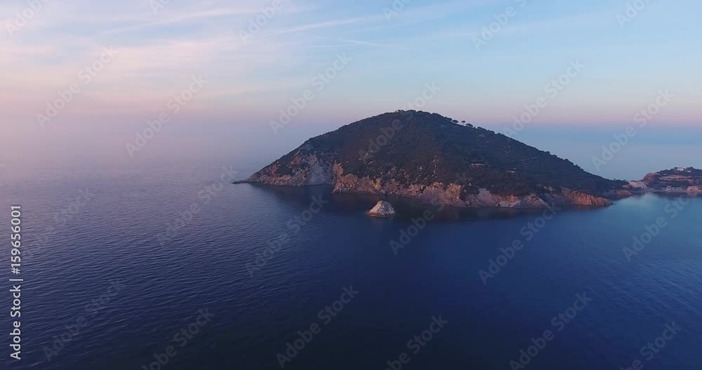Aerial shot of beautiful little island on sunset with very calm sea in Tuscany, Italy, 4K Aerial shot of beautiful little island on sunset with very calm sea in Tuscany, Italy, 4K