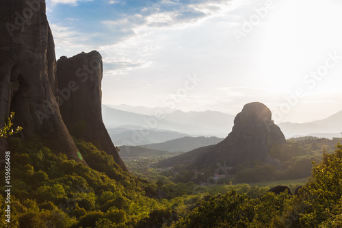 misty at sunset of hot day on Moni Agias Varvaras Roussanou on top of rock Meteora, Greece. photo