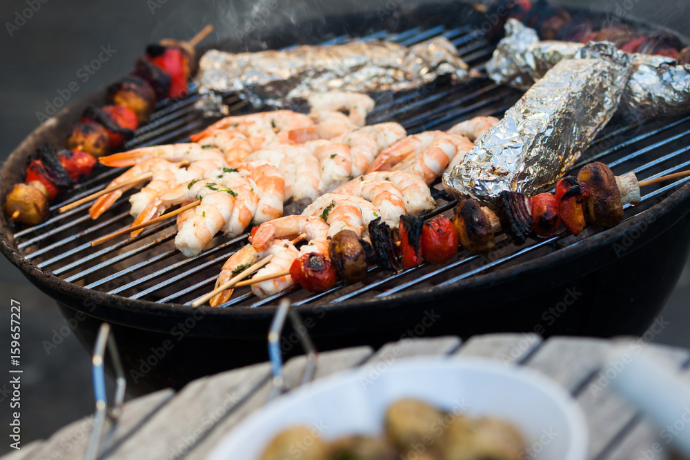 barbecue in the garden - summer- prawns and vegetables on skewers