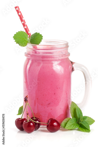 Glass of berry smoothie with cherries isolated on white background