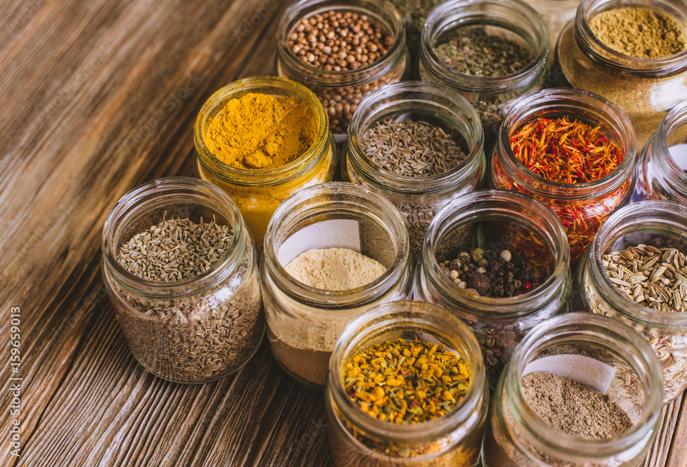 Various colorful kinds of spices on rustic wooden table, top view Various colorful kinds of spices on rustic wooden table, top view