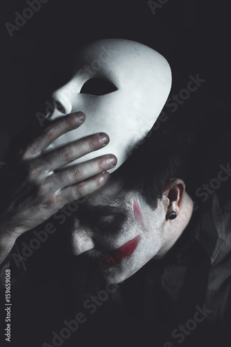 clown removing white mask