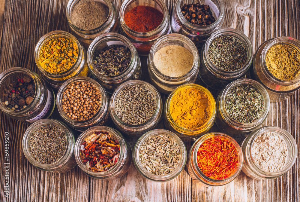 Various colorful kinds of spices on rustic wooden table, top view Various colorful kinds of spices on rustic wooden table, top view