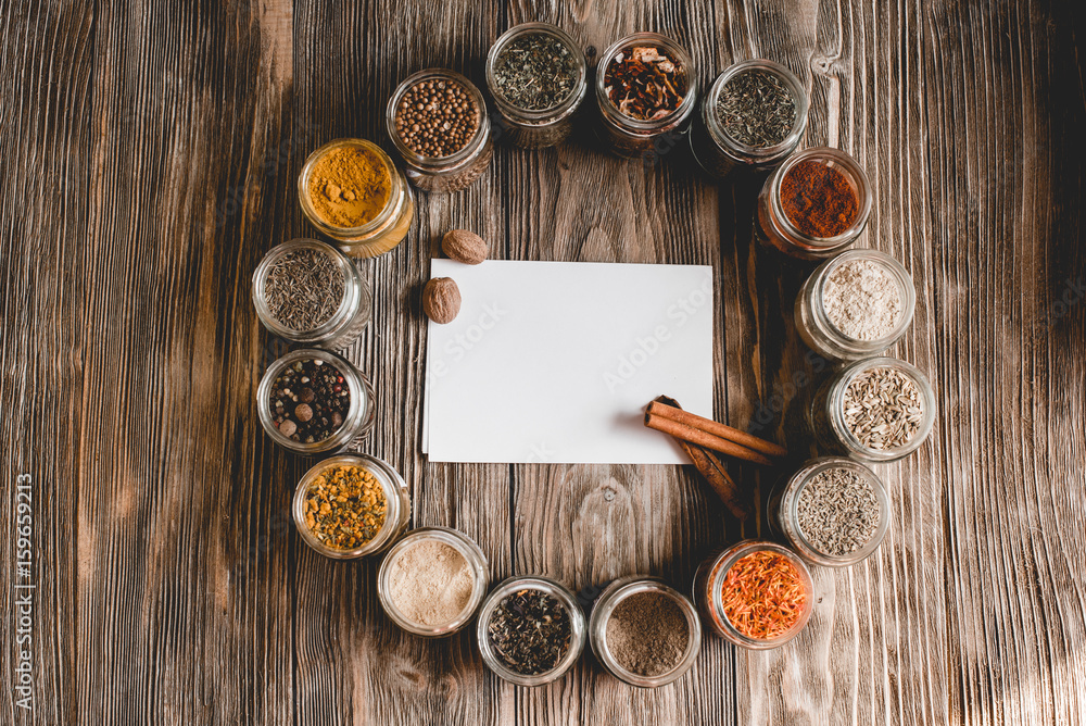 Various colorful kinds of spices on rustic wooden table, top view with copy space Various colorful kinds of spices on rustic wooden table, top view with copy space
