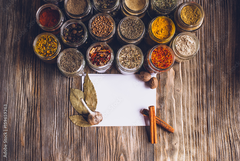 Various colorful kinds of spices on rustic wooden table, top view with copy space Various colorful kinds of spices on rustic wooden table, top view with copy space