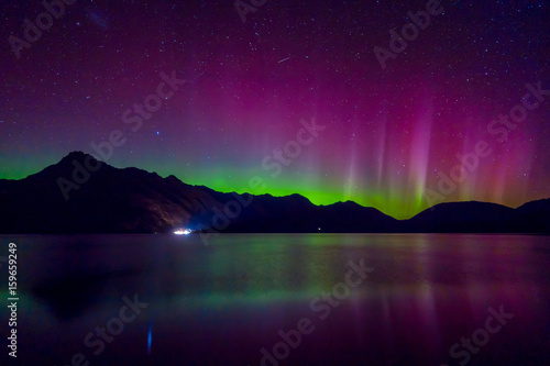 Fotografie Beautiful Aurora Australis and milky way over Lake Wakatipu, Kinloch, New Zealan