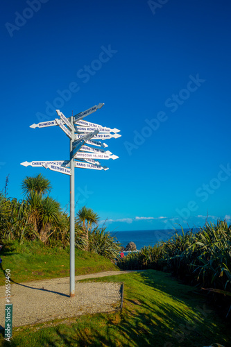 SOUTH ISLAND, NEW ZEALAND- MAY 23, 2017: An unidentified people looking at signpost at Cape Foulwind on the west coast of the South Island of New Zealand