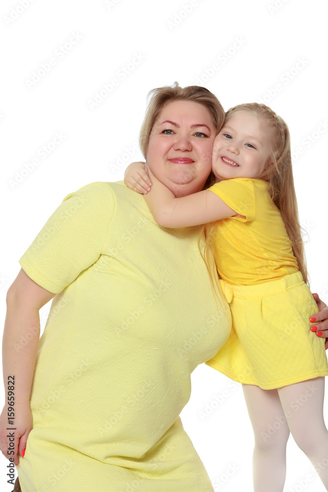 A happy mother hugs her beloved daughter.