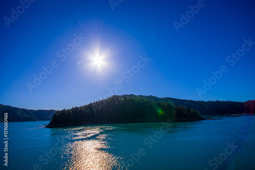 Beautiful landscape with sun shines in the sky with gorgeous blue sky in a sunny day seen from ferry from north island to south island, in New Zealand