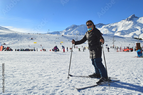 Young happy woman enjoys the snow in the ski resort Las Leñas in Mendoza, Argentina