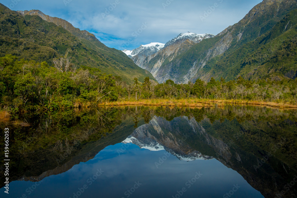 Small pond peters pond with reflection of mountain glacier Franz Josef Glacier in New Zealand Small pond peters pond with reflection of mountain glacier Franz Josef Glacier in New Zealand