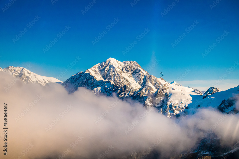 A Wide Panorama of Snowy Mountains with some clouds around, Southern Alps located in south island, in New Zealand