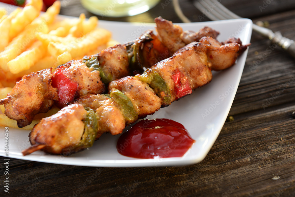Skewers with fries and salad