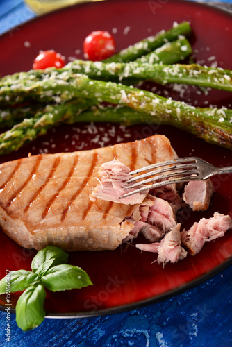 Grilled Tuna steak with roasted asparagus and parmesan photo