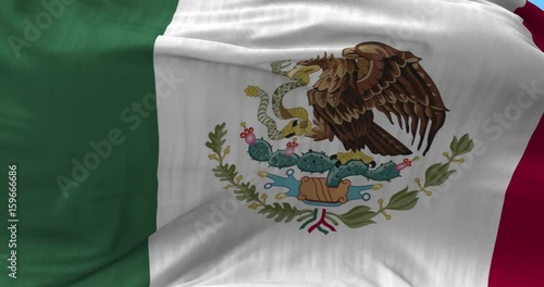 Close up Mexico flag blowing in the wind, looped slowmotion, 4K photo