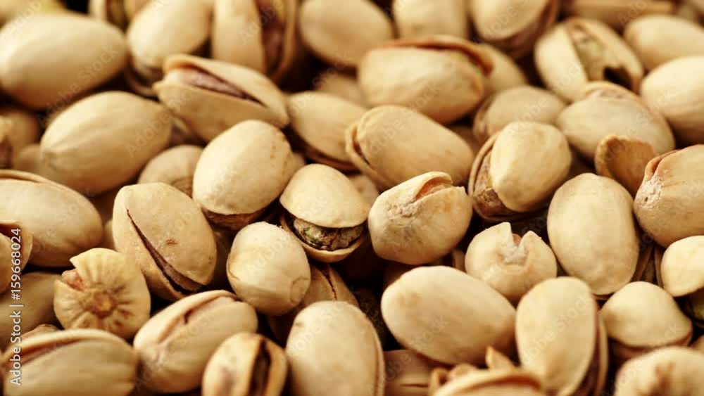 Food background. Roasted pistachio nuts seed with shell close up. Dieting concept. Dolly slider shot 4K ProRes HQ codec Food background. Roasted pistachio nuts seed with shell close up. Dieting concept. Dolly slider shot 4K ProRes HQ codec