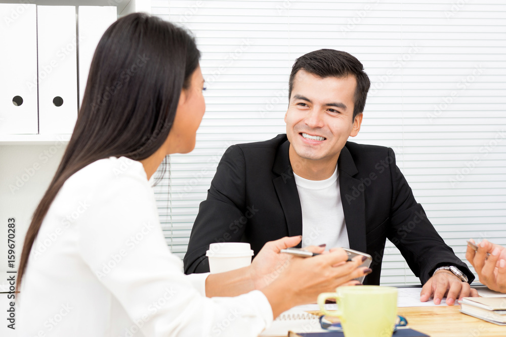 Businessman and businesswoman discussing work in the meeting Businessman and businesswoman discussing work in the meeting