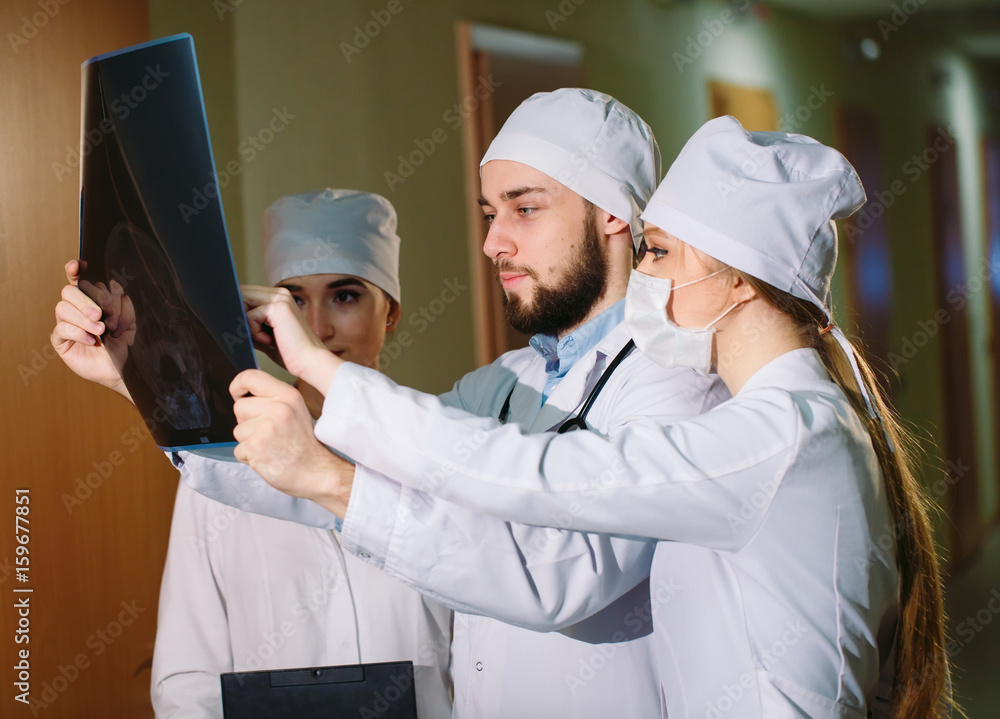 Doctors watching x-ray of patient.