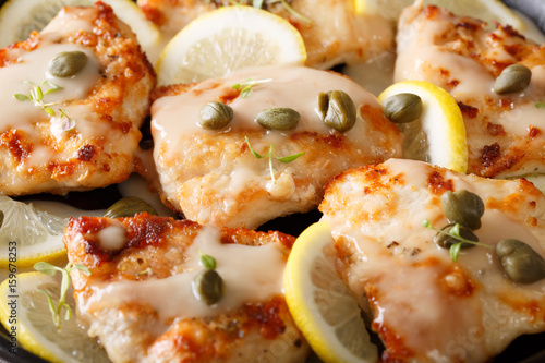 Delicious background: Fillet chicken piccata with lemon, thyme and capers macro