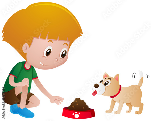 Little boy feeding pet dog