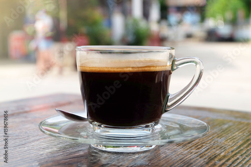 Hot coffee (Americano) on wooden table in relax morning. photo