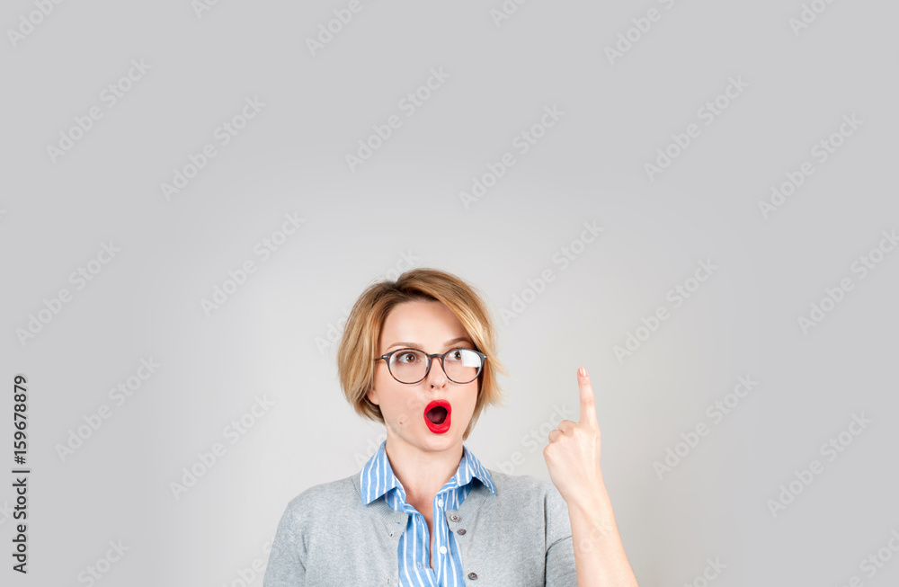 Beautiful business woman showing finger up and smiling looking up Beautiful business woman showing finger up and smiling looking up