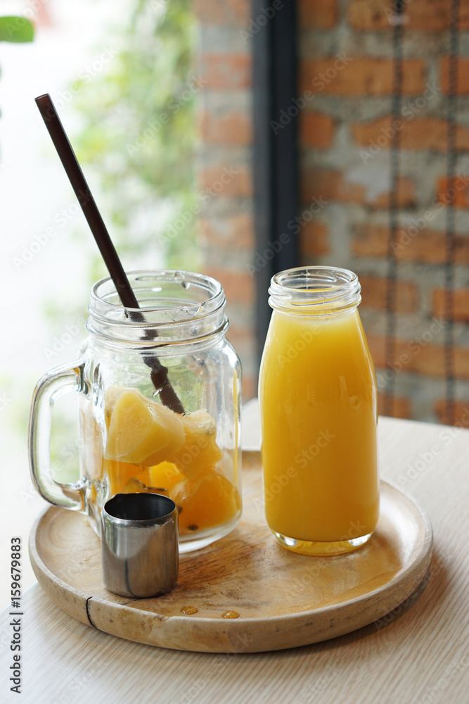 Passion fruit juice ice cubes in the jar served with Bottle of Passion fruit juice and lemon. Passion fruit juice ice cubes in the jar served with Bottle of Passion fruit juice and lemon.