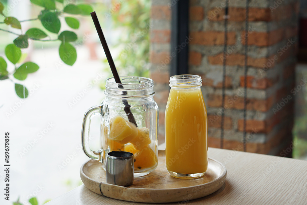 Passion fruit juice ice cubes in the jar served with Bottle of Passion fruit juice and lemon. Passion fruit juice ice cubes in the jar served with Bottle of Passion fruit juice and lemon.