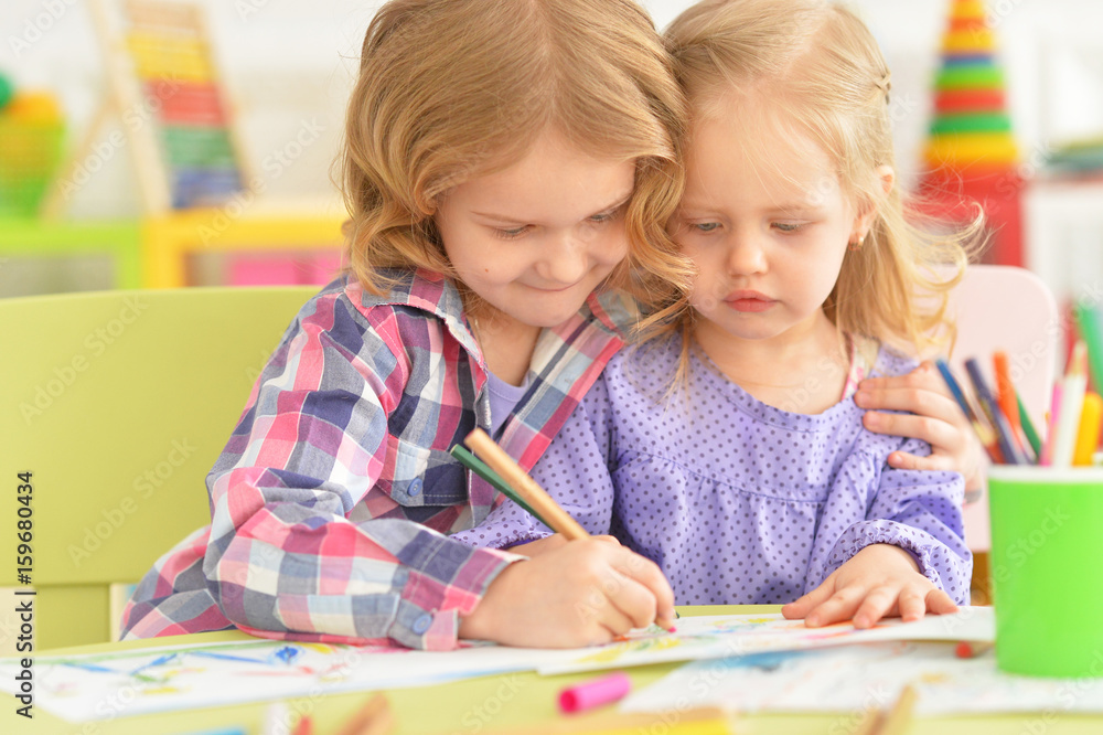 Cute little girls drawing with pencils Cute little girls drawing with pencils