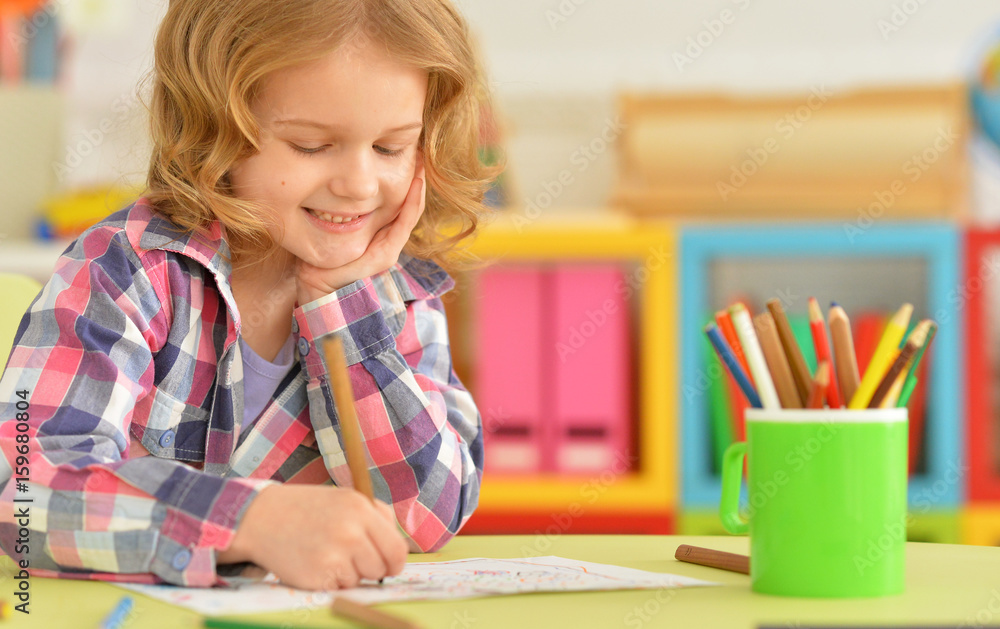 Cute little girl drawing with pencil Cute little girl drawing with pencil