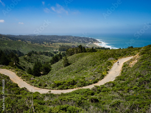 Mountain biker with Montara beach and pacific ocean in the background