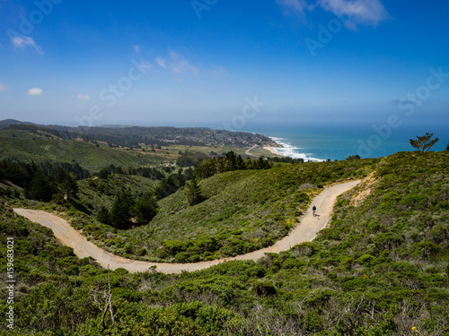 Mountain biker with Montara beach and pacific ocean in the background © Jennifer Jean
