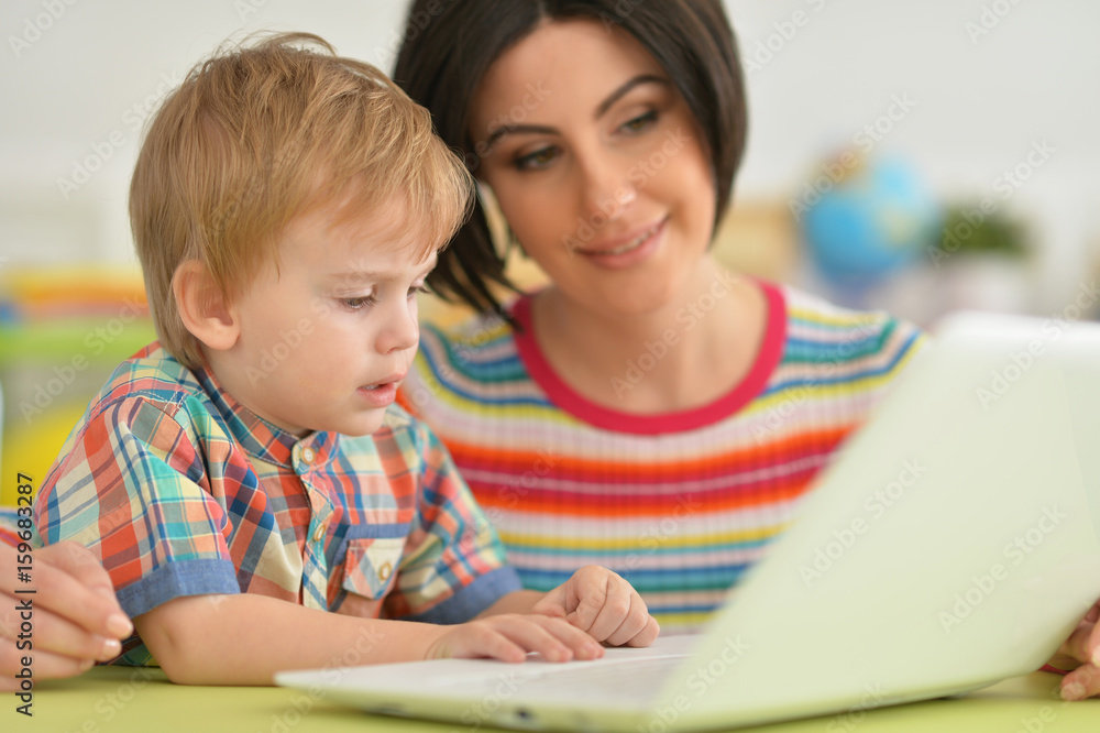 Mother and son using modern laptop Mother and son using modern laptop