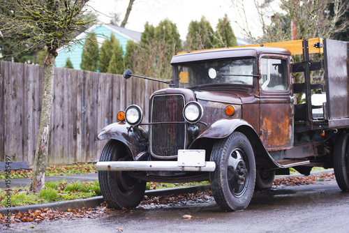 Old retro rusty truck on the road in the rain
