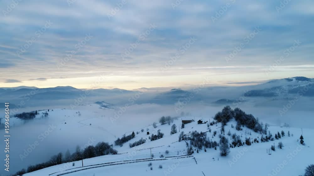 Aerial view in foggy sunset winter mountain Aerial view in foggy sunset winter mountain