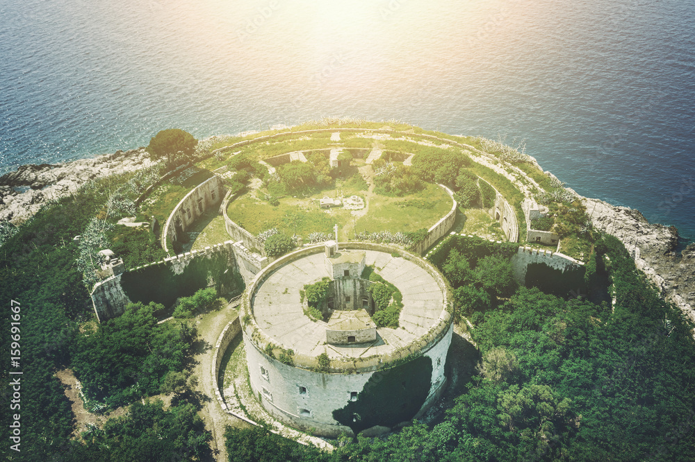 Round stone fortress on the beach in the sunlight, top view