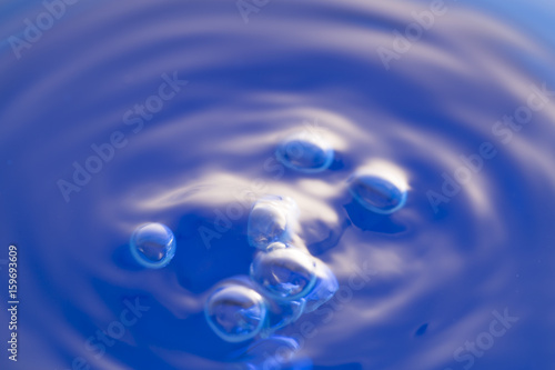 Water bubbles and swirl using blue lighting.