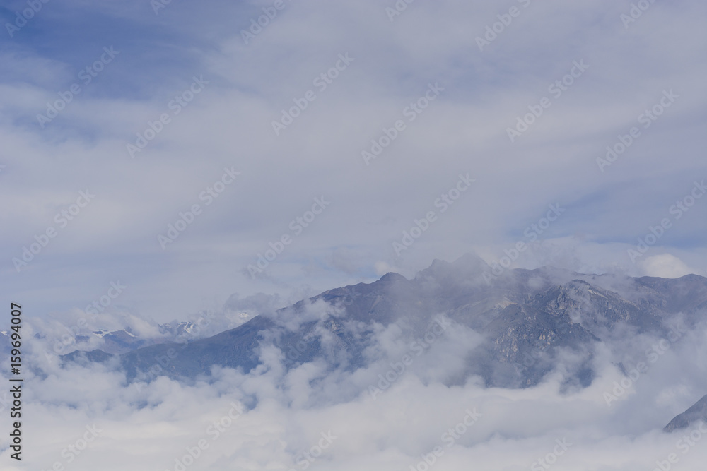 Andes peaks emerging from a sea of clouds, view from Colca Valley, Peru.
