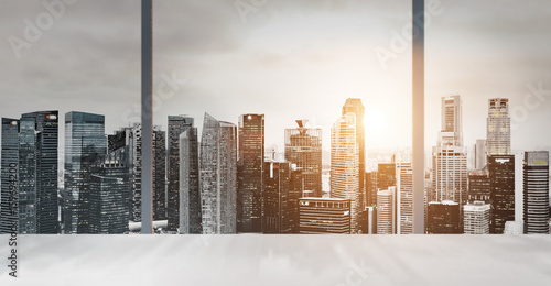 Photography Desk with blurred panoramic view of Singapore downtown and skyline at sunset in office window
