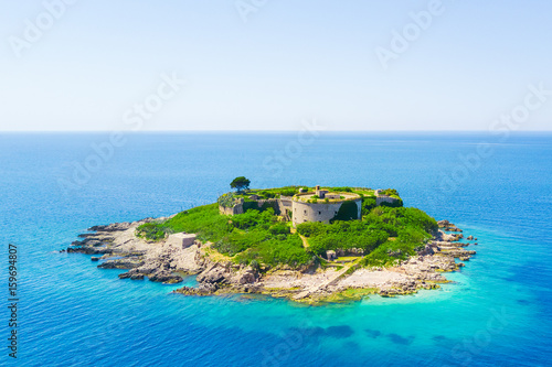 Top view of the island with a fortress in the sunlight