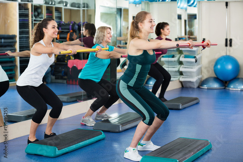 Females working out on aerobic step platform
