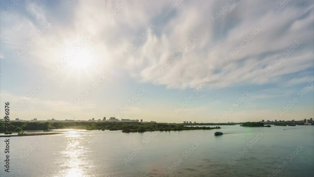 Sunbeams over river and ships at sunset skyscrapers in the background Sunbeams over river and ships at sunset skyscrapers in the background