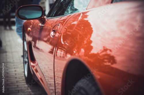 Headlights and body of an old classic car at an exhibition of vintage cars