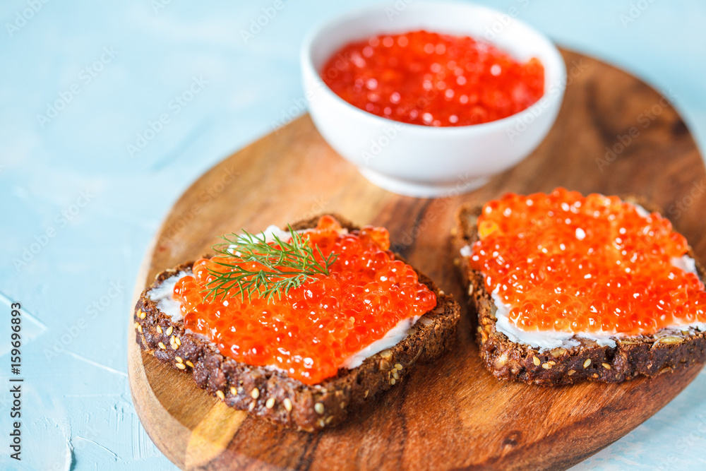 Sandwiches with red salmon caviar and rye bread. Sandwiches with red salmon caviar and rye bread.