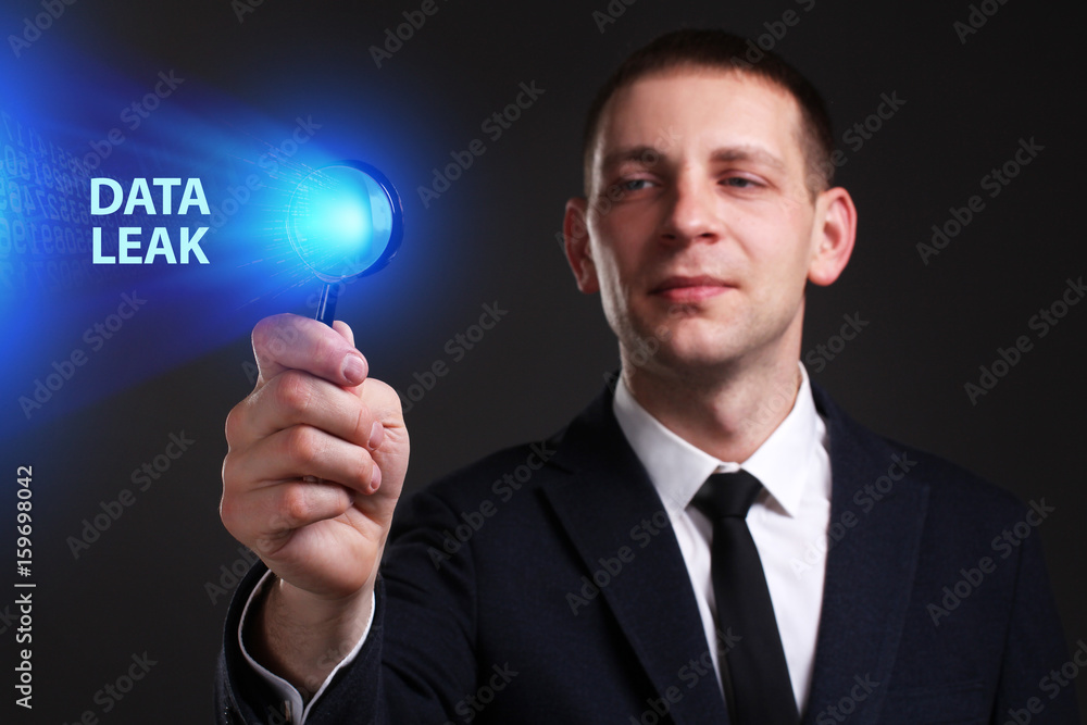 The concept of business, technology, the Internet and the network. A young entrepreneur working on a virtual screen of the future and sees the inscription: Data leak The concept of business, technology, the Internet and the network. A young entrepreneur working on a virtual screen of the future and sees the inscription: Data leak
