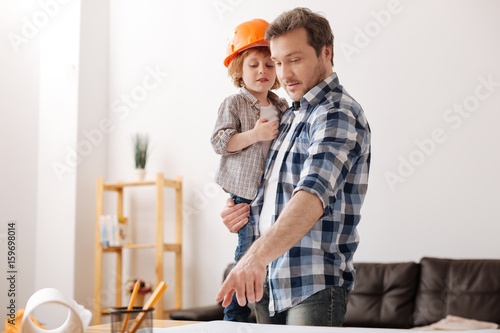 фотографія Delighted boy being glad to be hand of his father