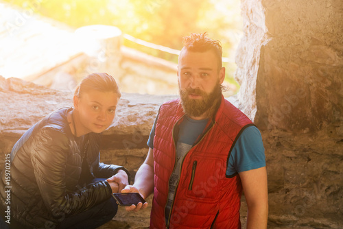 Young man and woman with a phone near the window in the sunlight © watman